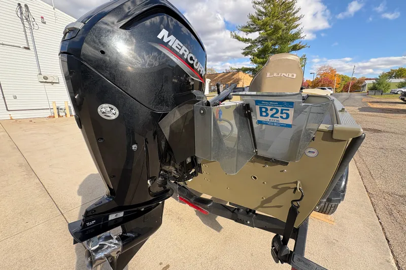 Slide: The Image of 2022 Lund 1800 Alaskan Tiller boat with Mercury outboard motor, parked outdoors. - 26