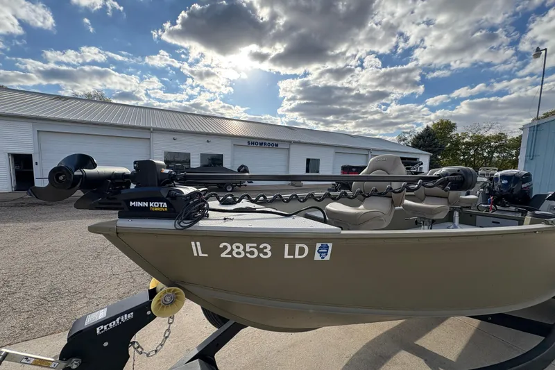 Slide: The Image of 2022 Lund 1800 Alaskan Tiller boat with Minn Kota motor, parked outside showroom. - 7