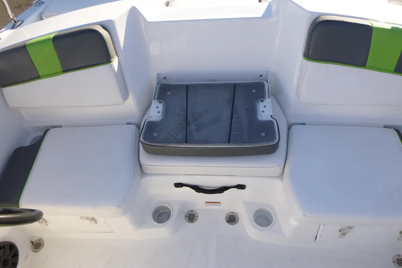 Slide: The Image of 2024 Tahoe T16 boat interior with white and green seating, featuring storage compartments. - 10