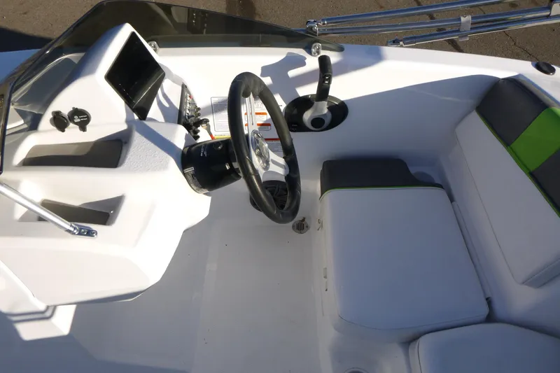 Slide: The Image of 2024 Tahoe T16 boat interior with steering wheel and seating area. - 12