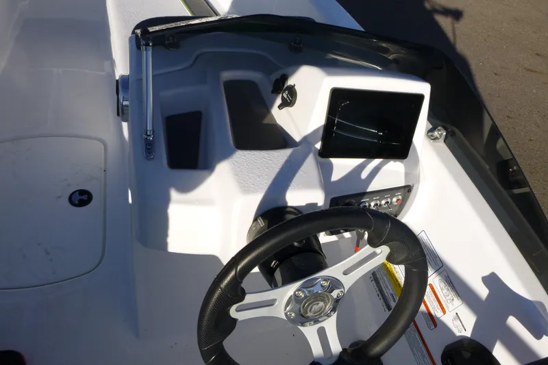 Slide: The Image of 2024 Tahoe T16 boat dashboard with steering wheel and control panel. - 13