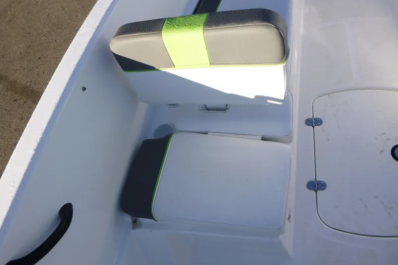 Slide: The Image of 2024 Tahoe T16 boat interior with green-accented seating and storage compartment. - 14
