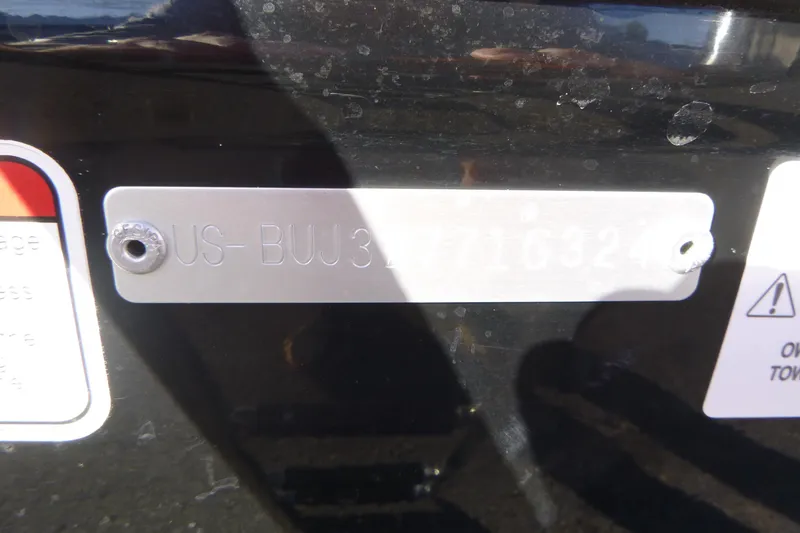 Slide: The Image of 2024 Tahoe T16 identification plate with engraved serial number on a black surface. - 16