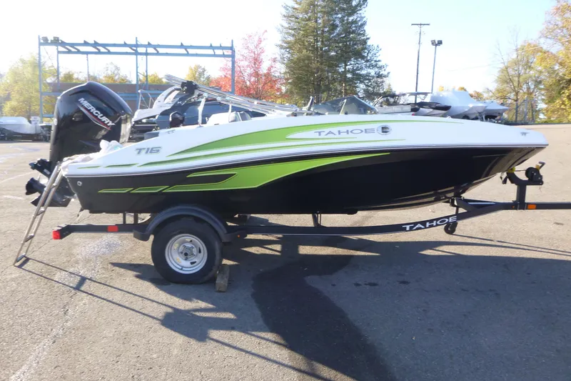 Slide: The Image of 2024 Tahoe T16 boat with green accents on a trailer in a parking lot. - 4