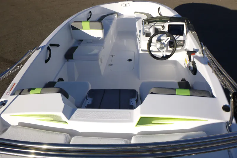 Slide: The Image of 2024 Tahoe T16 boat interior with modern steering and seating, featuring green accents. - 5