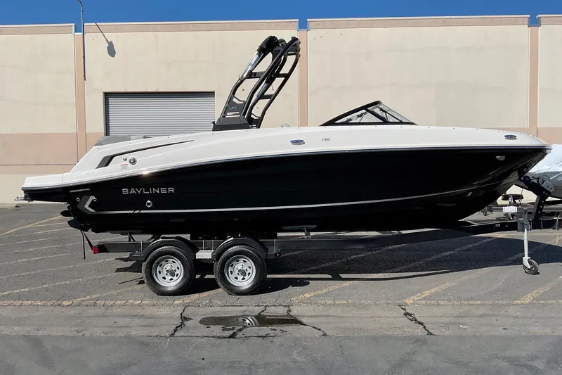 The Image of 2026 Bayliner VR6 Bowrider I/O on trailer, parked outdoors, side view. - 0