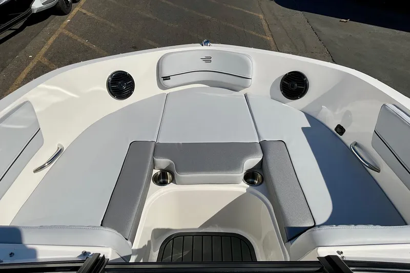 Slide: The Image of 2026 Bayliner VR6 Bowrider I/O boat interior with cushioned seating and cup holders. - 12