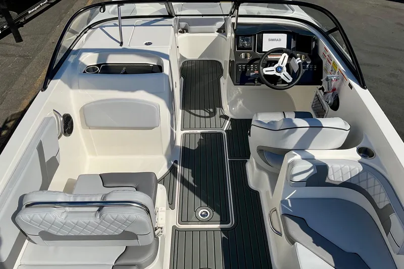 Slide: The Image of 2026 Bayliner VR6 Bowrider I/O interior with modern seating and steering console. - 13