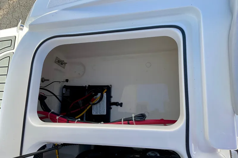 Slide: The Image of 2026 Bayliner VR6 Bowrider I/O battery compartment with wiring and storage space. - 15