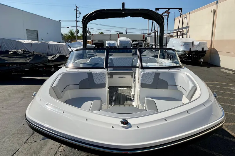 Slide: The Image of 2026 Bayliner VR6 Bowrider I/O boat with spacious seating, parked outdoors. - 19