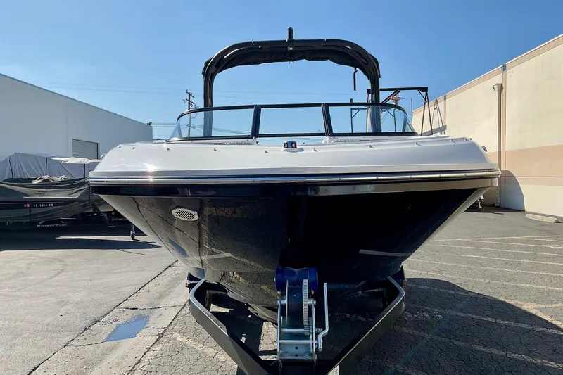 Slide: The Image of 2026 Bayliner VR6 Bowrider I/O boat on trailer in sunny outdoor setting. - 3