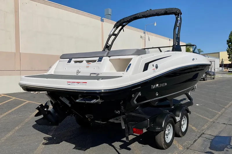 Slide: The Image of 2026 Bayliner VR6 Bowrider I/O boat on trailer, parked outdoors. - 5