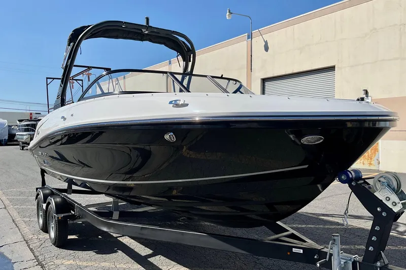 Slide: The Image of 2026 Bayliner VR6 Bowrider I/O on trailer, parked outdoors, sunny day. - 7