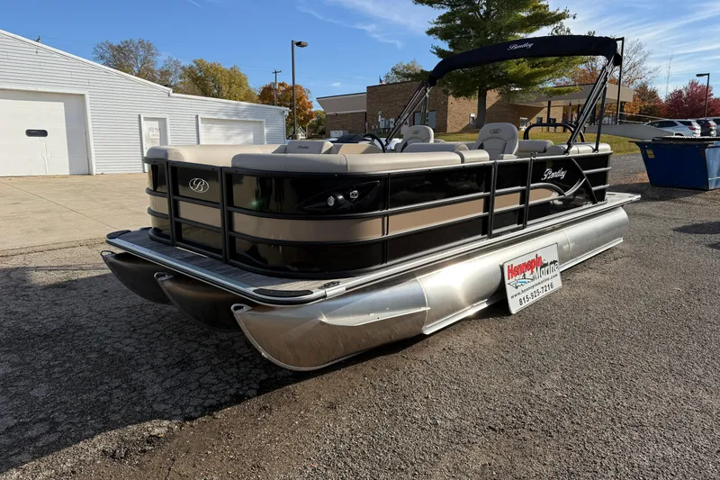 Slide: The Image of 2026 Bentley Pontoons Legacy 223 Navigator in a parking lot, showcasing sleek design. - 1