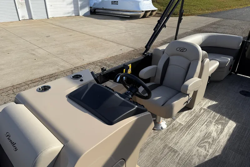 Slide: The Image of 2026 Bentley Pontoons Legacy 223 Navigator interior with captain's chair and console. - 12