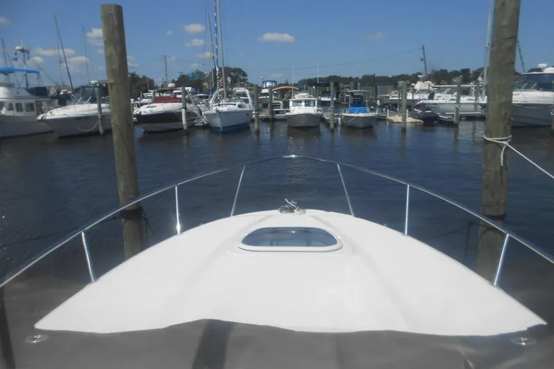 Slide: The Image of Bow view of 2008 Sea Ray 260 Sundancer docked at marina with other boats. - 12