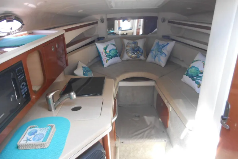 Slide: The Image of Interior of 2008 Sea Ray 260 Sundancer with cozy seating and nautical-themed decor. - 13