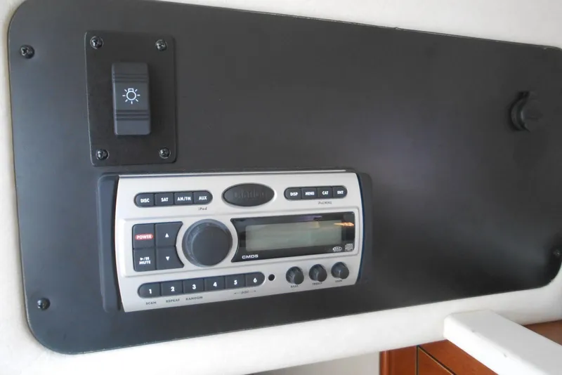 Slide: The Image of 2008 Sea Ray 260 Sundancer stereo system with control panel and light switch. - 16