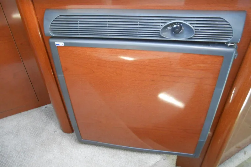 Slide: The Image of 2008 Sea Ray 260 Sundancer interior with wood-finish mini fridge. - 19