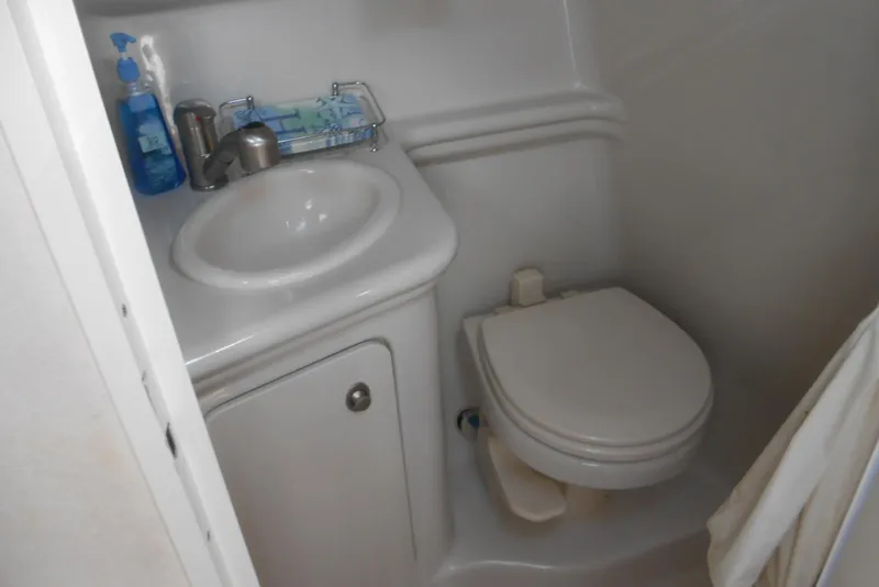 Slide: The Image of Compact bathroom in 2008 Sea Ray 260 Sundancer boat, featuring sink and toilet. - 20