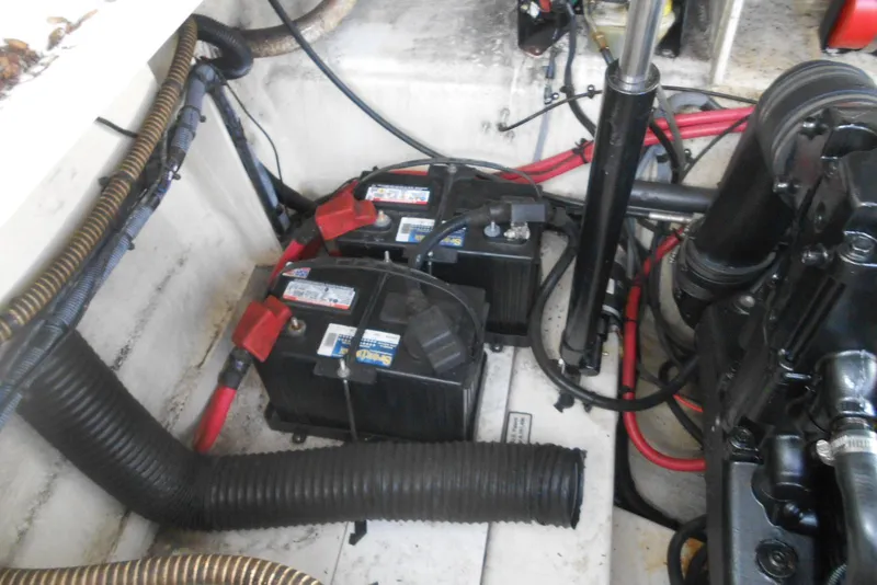 Slide: The Image of Engine compartment of a 2008 Sea Ray 260 Sundancer with visible batteries and wiring. - 23