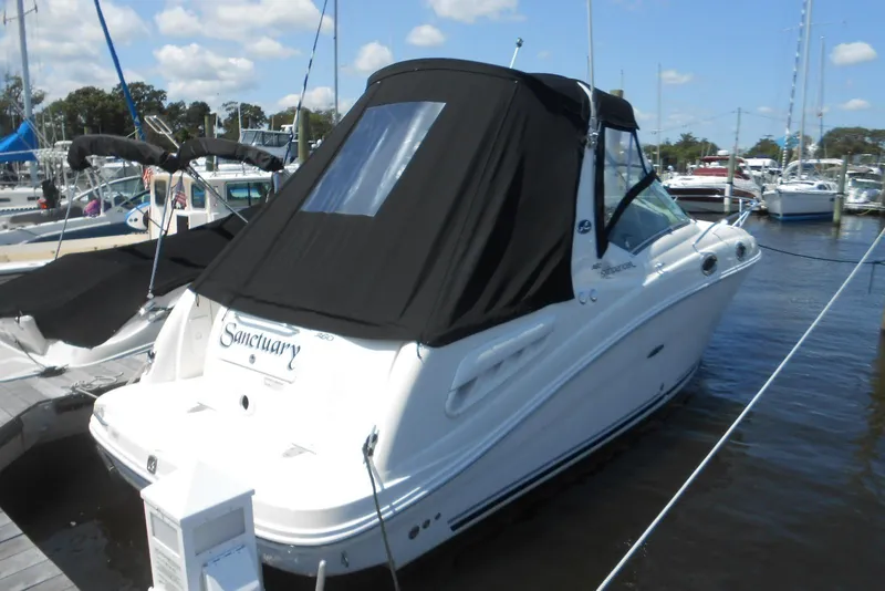 Slide: The Image of 2008 Sea Ray 260 Sundancer boat docked with black canopy in marina. - 3