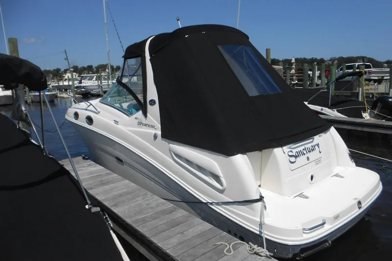 Slide: The Image of 2008 Sea Ray 260 Sundancer boat docked at marina with black canopy. - 4