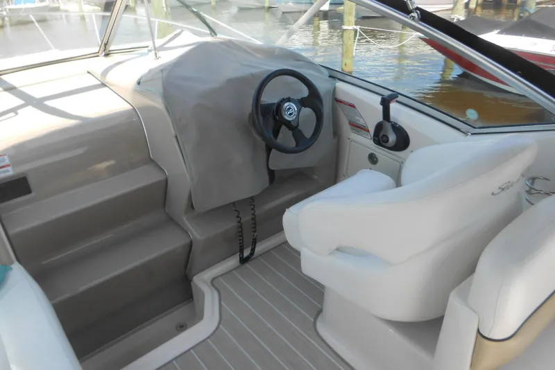 Slide: The Image of 2008 Sea Ray 260 Sundancer helm with steering wheel and captain's chair. - 5