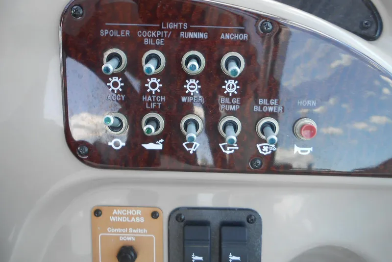 Slide: The Image of Control panel of a 2008 Sea Ray 260 Sundancer boat with various switches. - 7