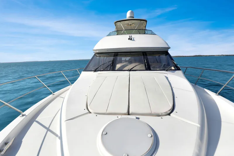 Slide: The Image of 2005 Carver 560 Voyager yacht cruising on open water under clear blue skies. - 19