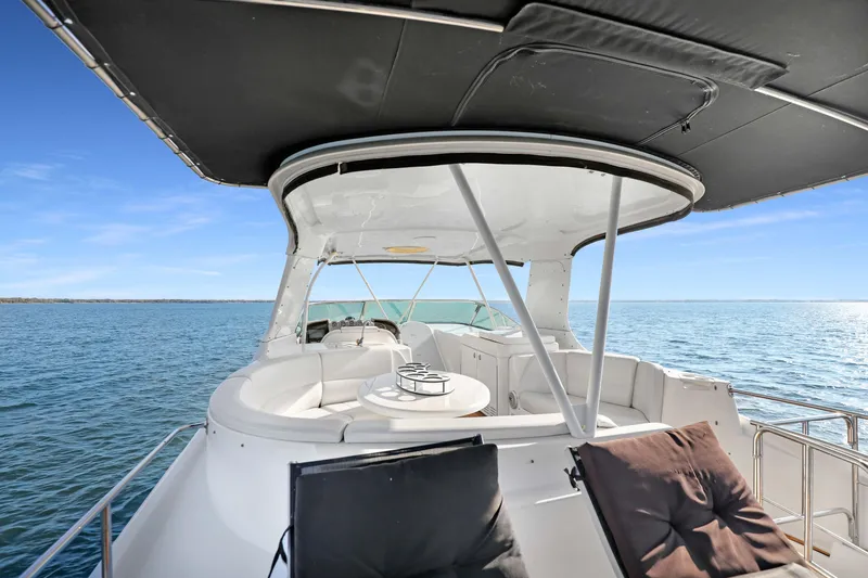 Slide: The Image of 2005 Carver 560 Voyager yacht with spacious deck, cruising on open water. - 22