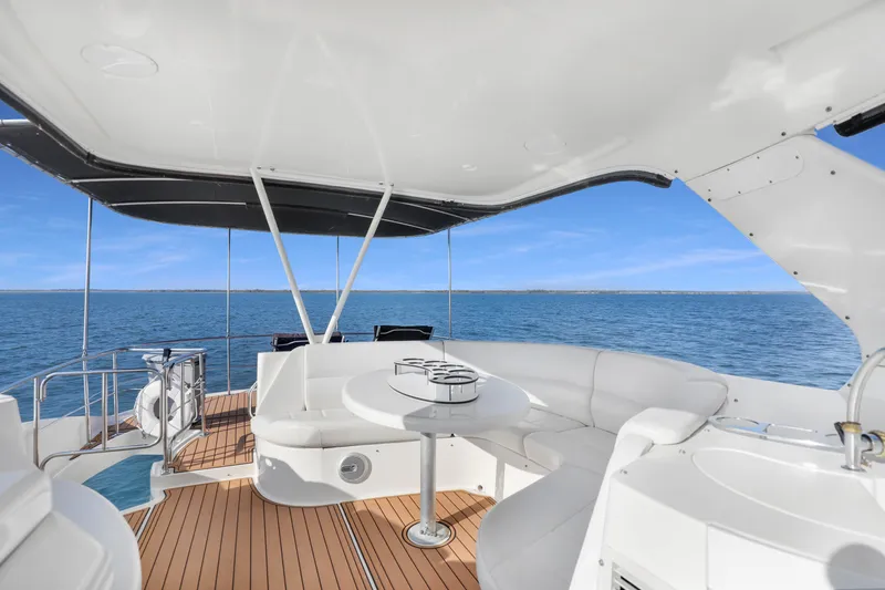 Slide: The Image of Luxurious 2005 Carver 560 Voyager yacht interior with ocean view and elegant seating area. - 27