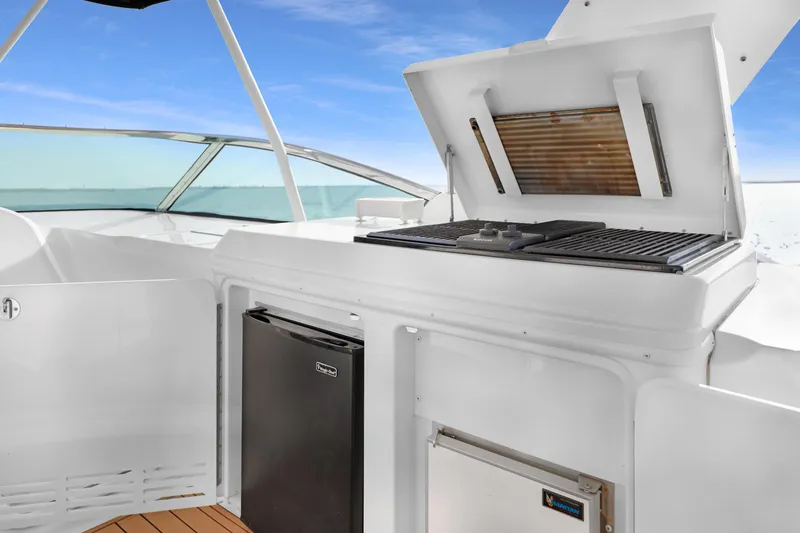 Slide: The Image of 2005 Carver 560 Voyager yacht with outdoor grill and mini fridge on deck. - 29