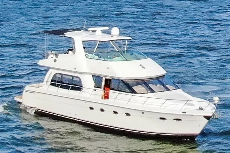 Slide: The Image of 2005 Carver 560 Voyager yacht cruising on open water. - 3