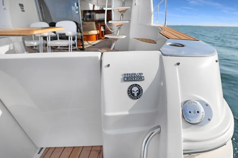 Slide: The Image of 2005 Carver 560 Voyager yacht deck with Trump Edition badge, overlooking the ocean. - 38