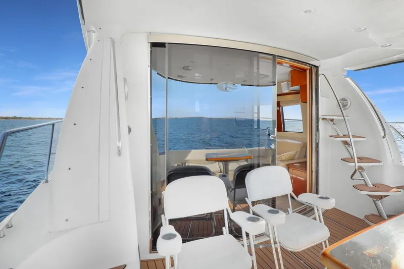 Slide: The Image of 2005 Carver 560 Voyager yacht interior with ocean view, featuring seating and elegant design. - 40