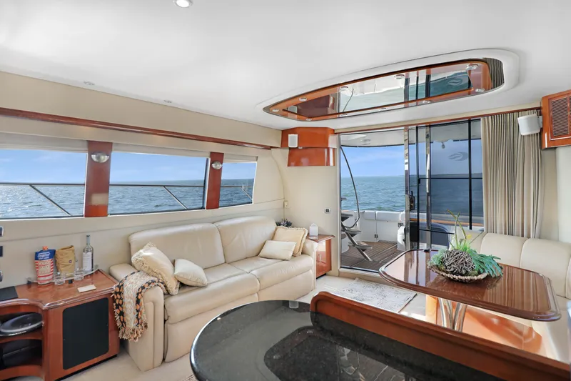 Slide: The Image of Luxurious 2005 Carver 560 Voyager yacht interior with ocean view, featuring elegant seating and decor. - 43