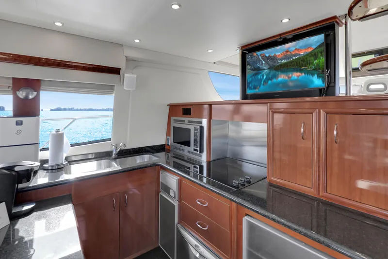 Slide: The Image of Luxurious kitchen interior of 2005 Carver 560 Voyager yacht with modern appliances and scenic view. - 48