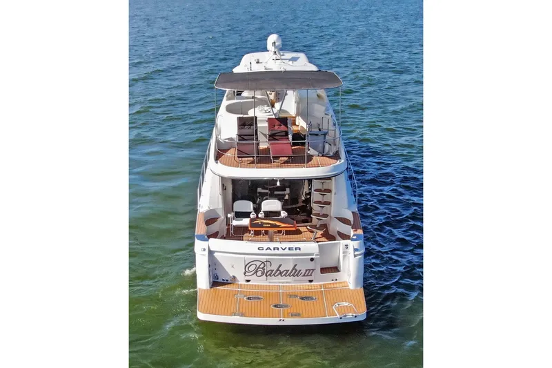 Slide: The Image of 2005 Carver 560 Voyager yacht on water, rear view, with spacious deck and seating. - 6