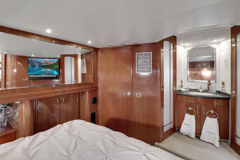 Slide: The Image of Luxurious 2005 Carver 560 Voyager cabin with wood finishes, TV, and ensuite bathroom. - 63