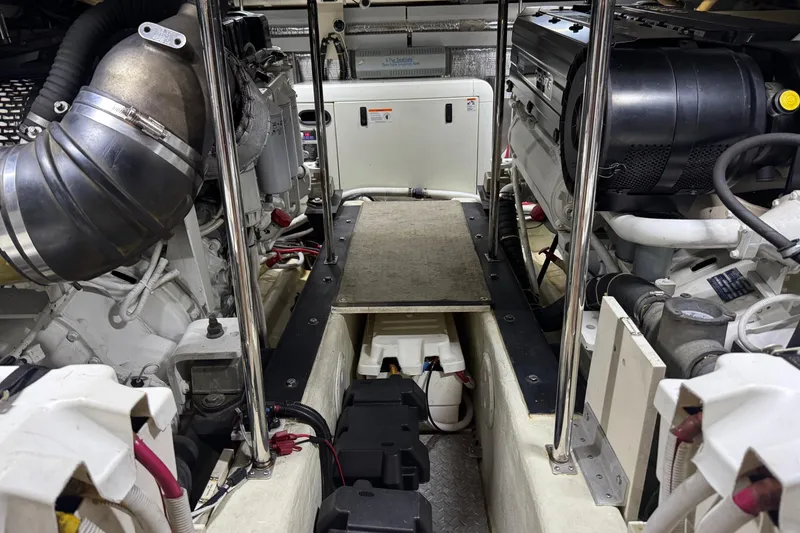Slide: The Image of Engine room of a 2005 Carver 560 Voyager yacht, showcasing mechanical components and systems. - 73