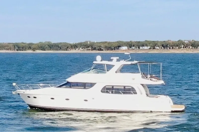 Slide: The Image of 2005 Carver 560 Voyager yacht cruising on a serene blue sea. - 8