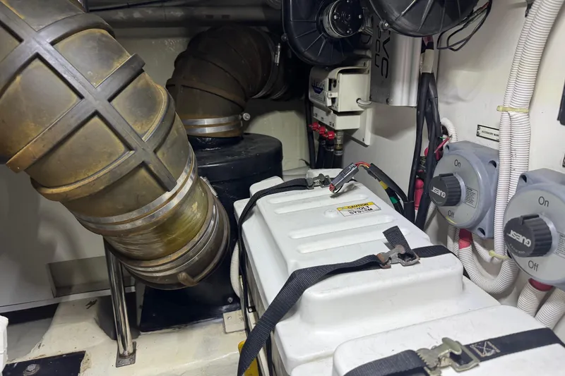 Slide: The Image of Engine room of a 2005 Carver 560 Voyager yacht, featuring mechanical components and wiring. - 80