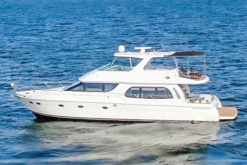 The Image of 2005 Carver 560 Voyager yacht cruising on open water. - 0