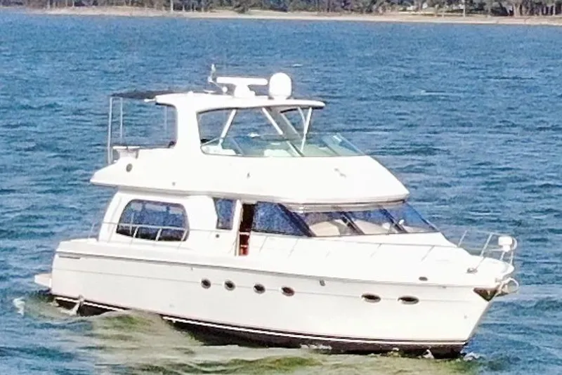 Slide: The Image of 2005 Carver 560 Voyager yacht cruising on open water. - 11