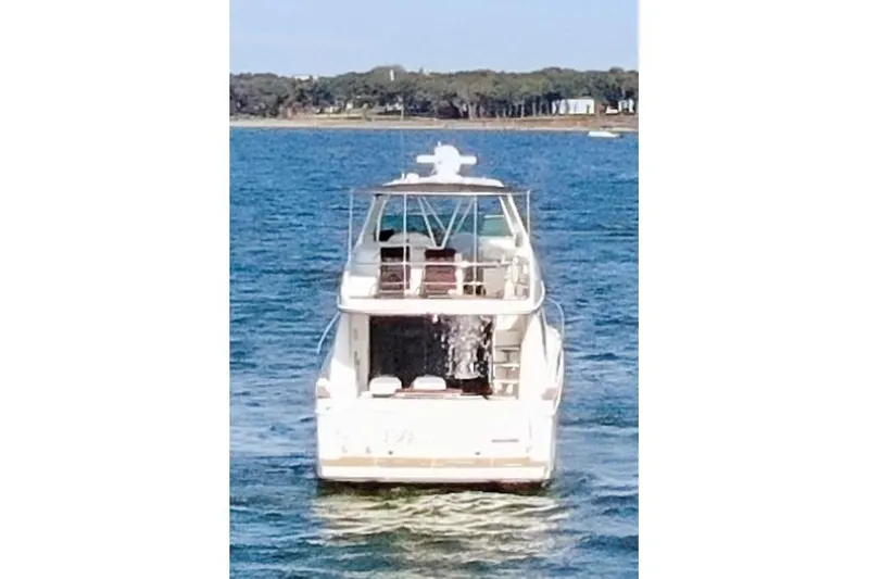 Slide: The Image of 2005 Carver 560 Voyager yacht cruising on open water. - 14