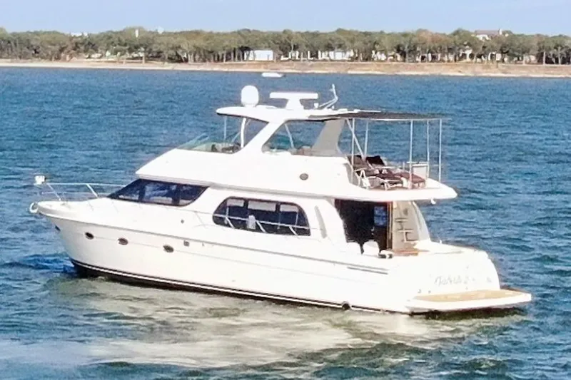 Slide: The Image of 2005 Carver 560 Voyager yacht cruising on a calm blue sea. - 16