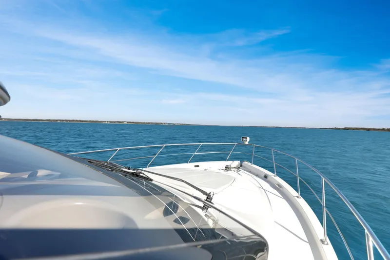 Slide: The Image of 2005 Carver 560 Voyager yacht cruising on open blue water under clear skies. - 20