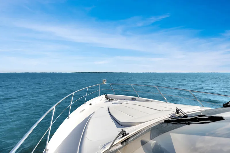Slide: The Image of 2005 Carver 560 Voyager yacht cruising on open blue sea under clear sky. - 21