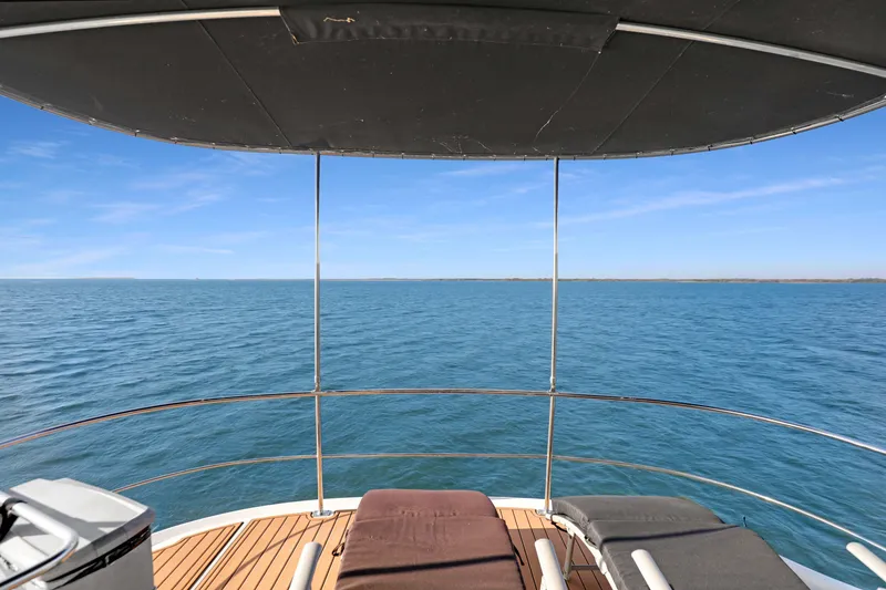 Slide: The Image of View from 2005 Carver 560 Voyager yacht deck overlooking serene ocean waters. - 24